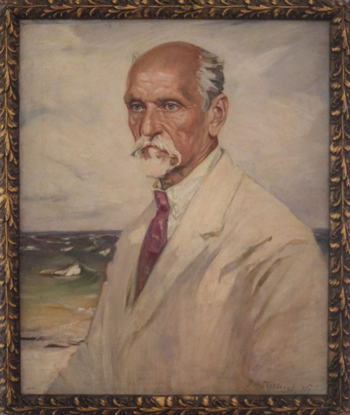 Jāņa Roberta Tilberga gleznotais Raiņa portrets. Rainis redzams līdz viduklim, baltā uzvalkā, jūras krastā